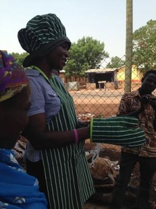 Consultant demonstrating the use of the right gear for processing Shea Butter